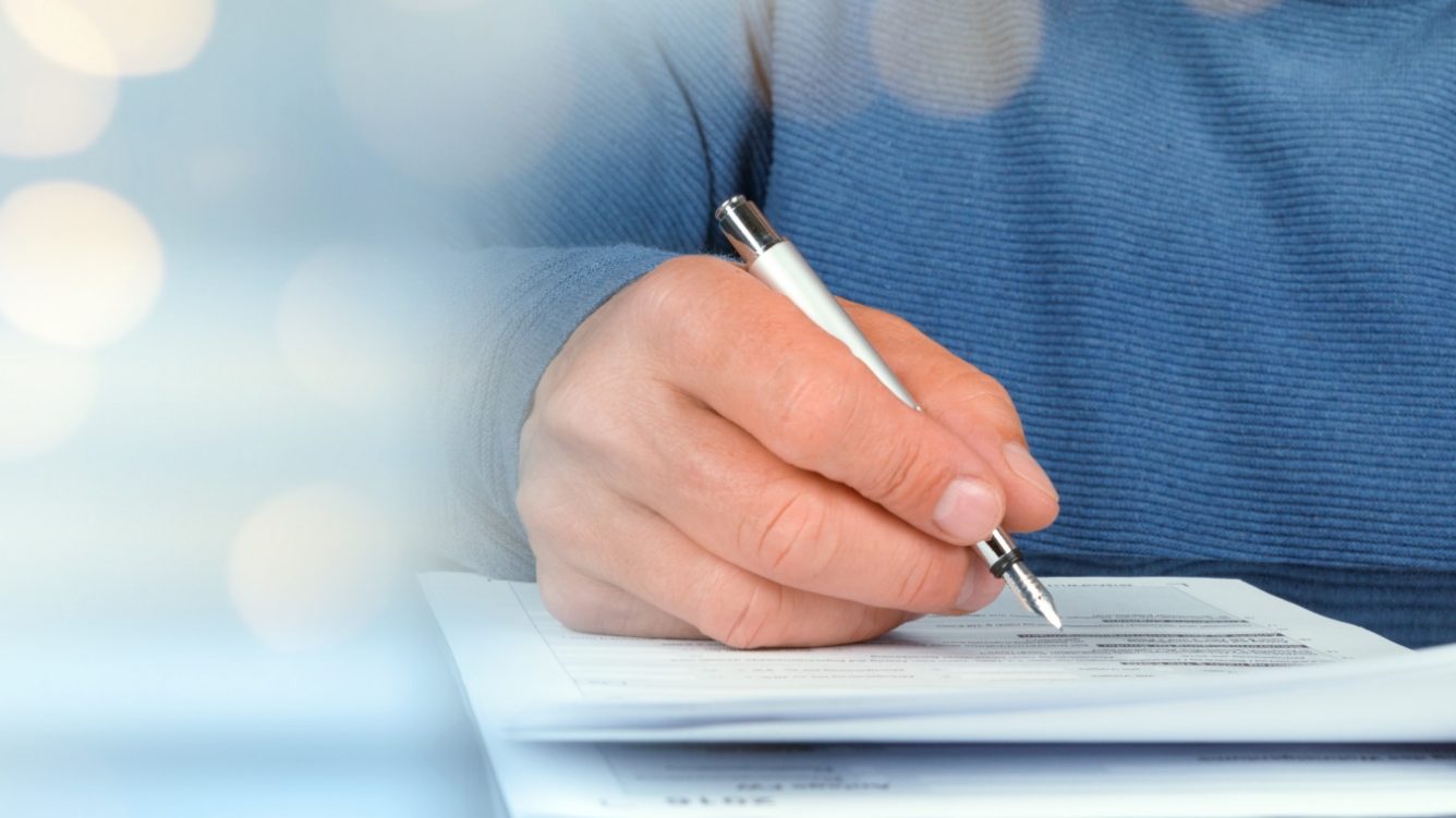 Man signing papers MAIN IMAGE